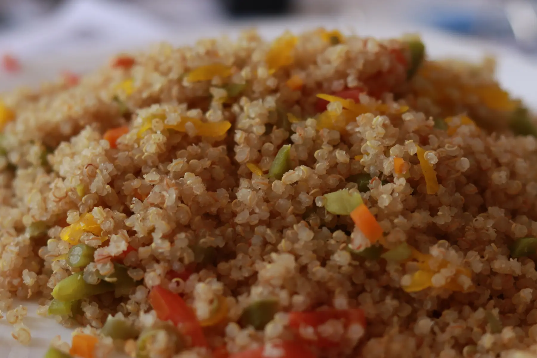 Primer plano de QMágica Quinua Real con Verduras tras 3 minutos: quinua suelta con zanahoria, zapallo, vainita, tomate y pimentón